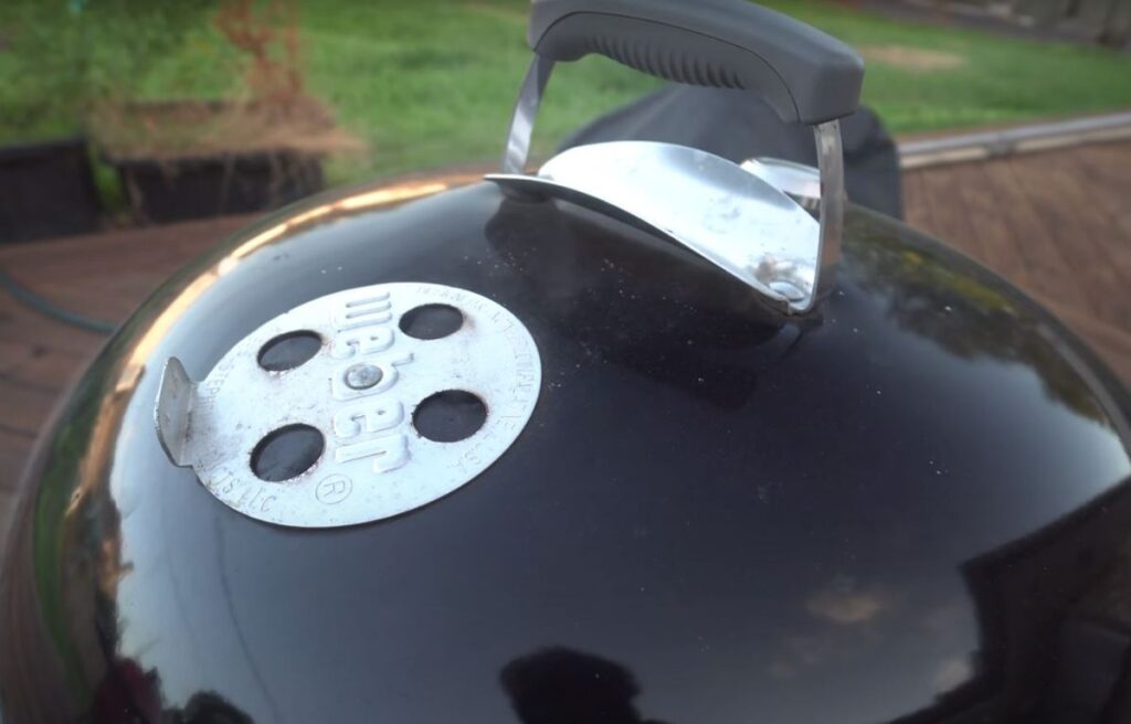 Top vents on a charcoal smoker to control temperature