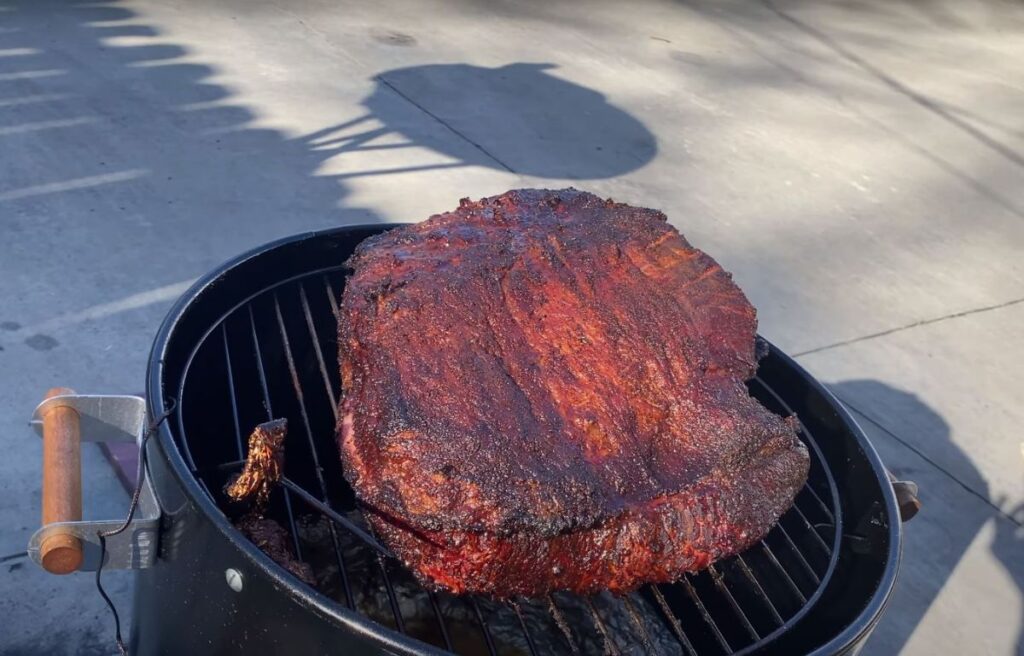 Low And Slow Smoking Brisket On A Charcoal Grill