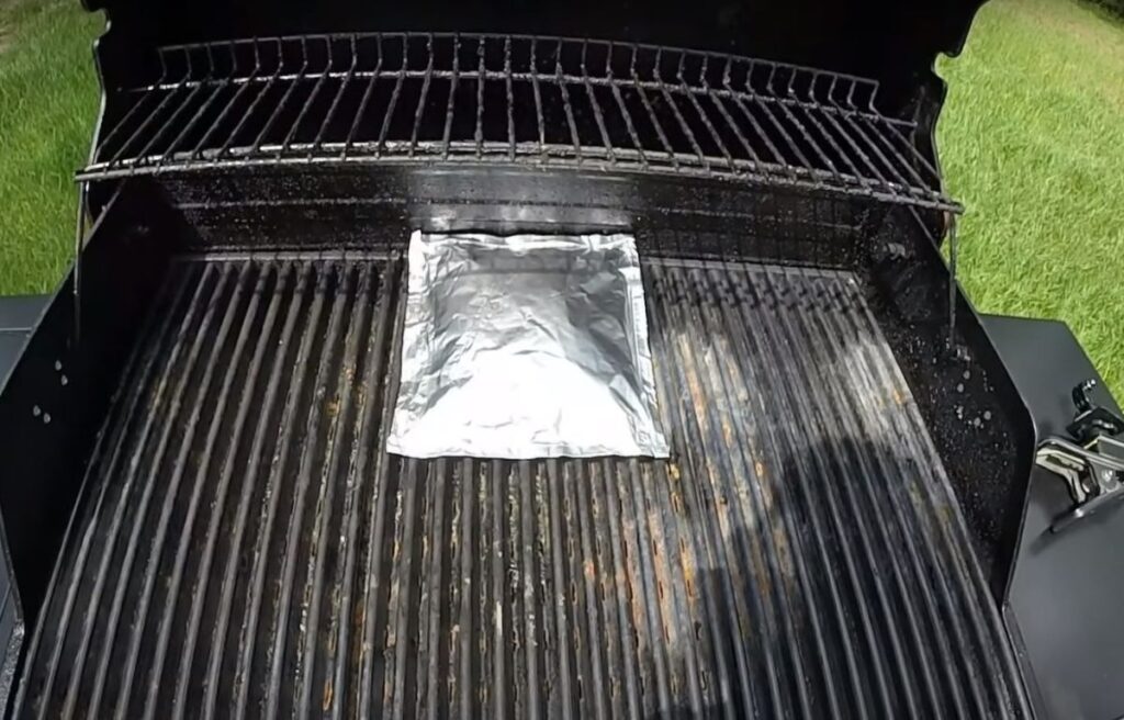 Using wood pellets on a gas grill by placing them in a foil packet