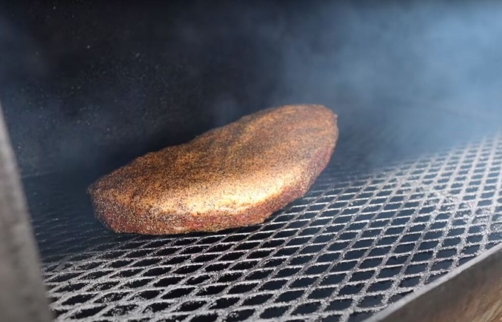 Placing the brisket inside the smoker