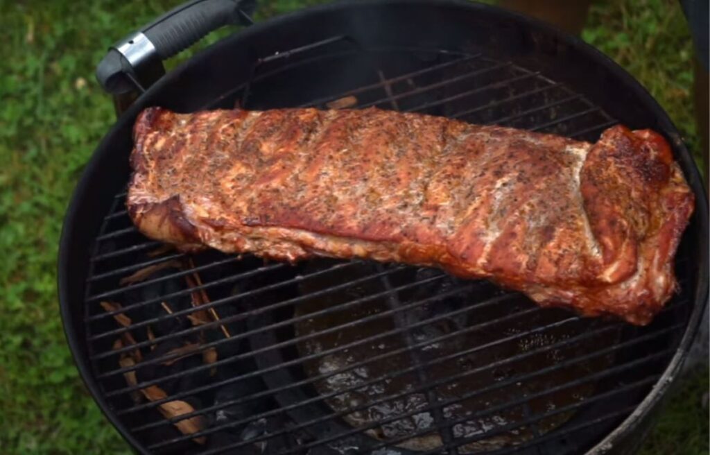 Grilling ribs on charcoal grill