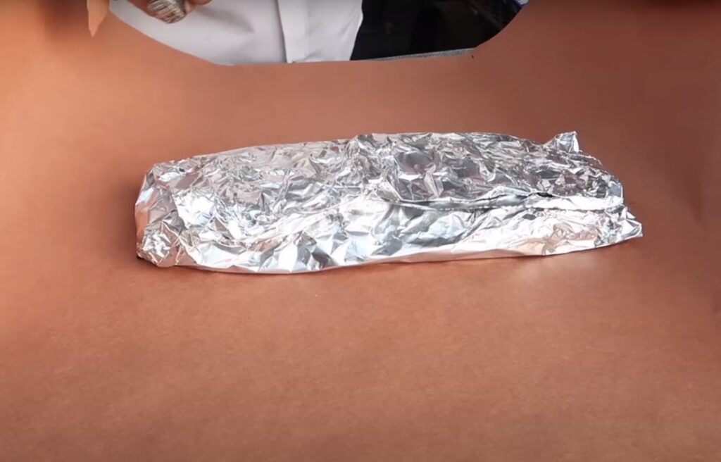 Wrapping ribs in aluminum foil before placing in the fridge