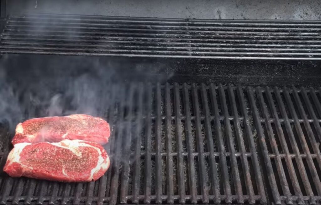 Grilling ribeye steak on a gas grill