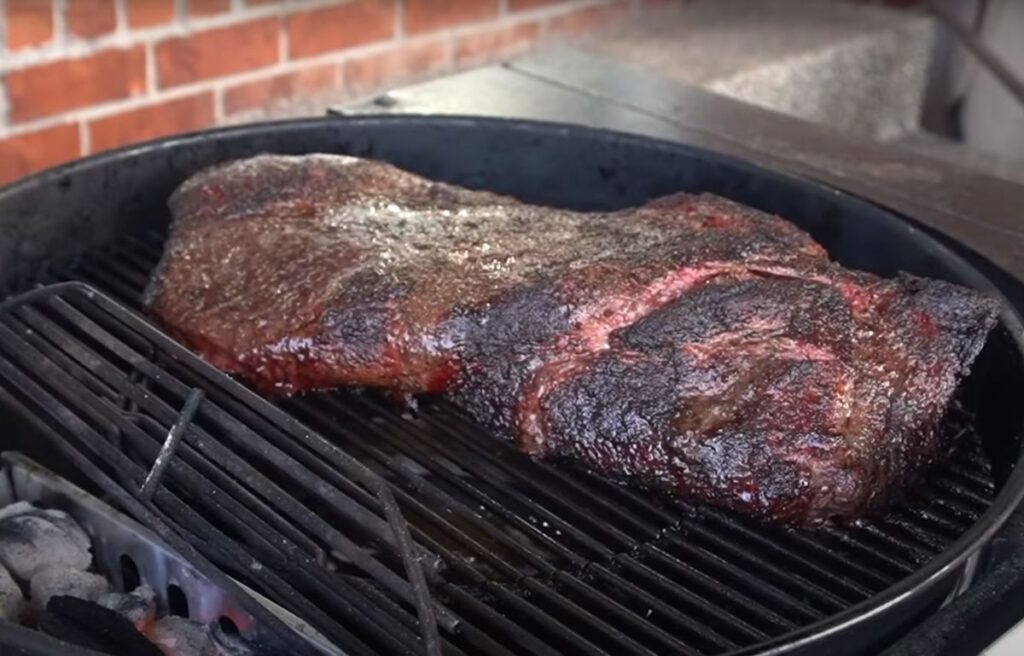Smoking a beef brisket on a charcoal smoker