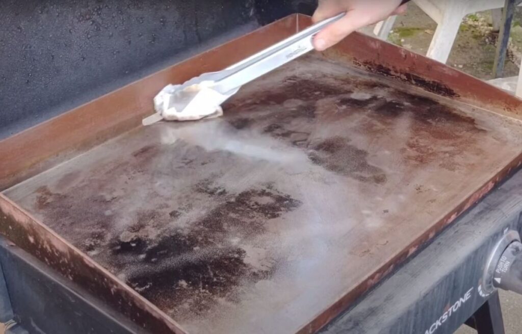 Wiping down the griddle surface